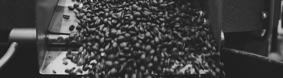coffee beans spiling from a coffee machine